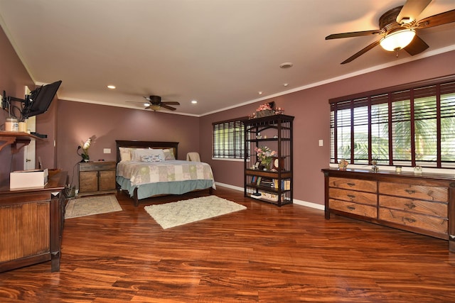 bedroom featuring crown molding, baseboards, and wood finished floors