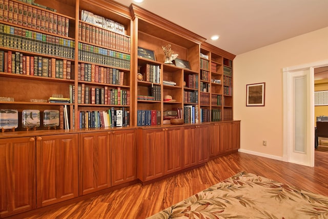 unfurnished room featuring recessed lighting, baseboards, and wood finished floors