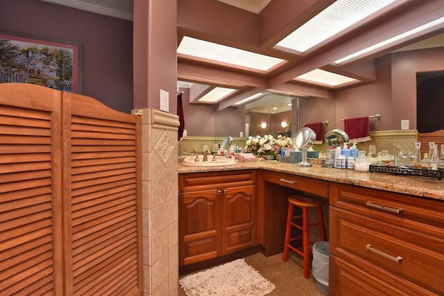 bathroom featuring vanity and tasteful backsplash