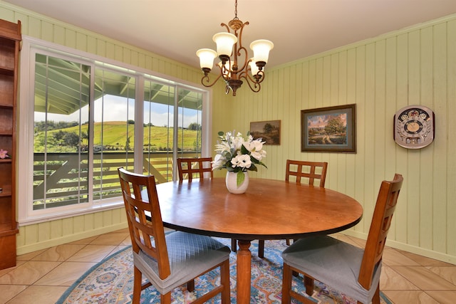 dining space featuring a notable chandelier, baseboards, and light tile patterned floors