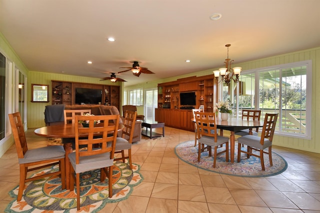 dining space featuring light tile patterned flooring, recessed lighting, and ceiling fan with notable chandelier