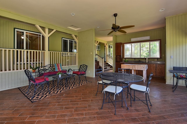 dining space featuring wood tiled floor, stairway, and ceiling fan