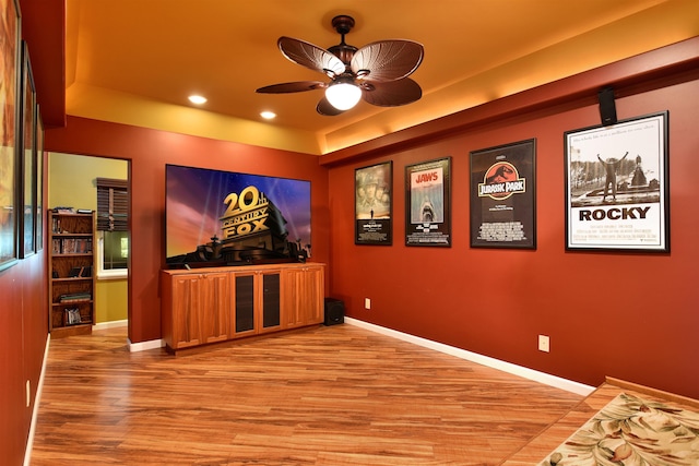 home theater with recessed lighting, a ceiling fan, baseboards, and light wood finished floors