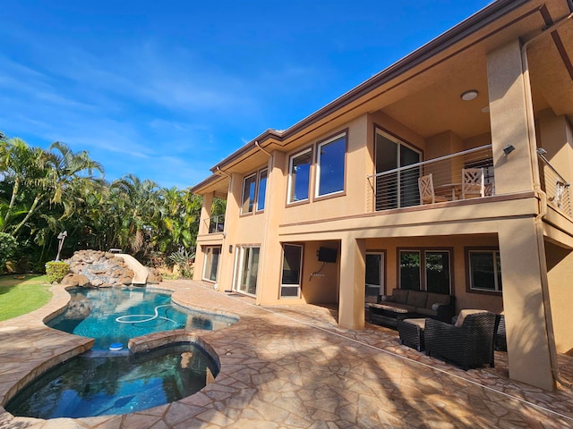 view of swimming pool with a patio area, an outdoor living space, an in ground hot tub, and a water slide