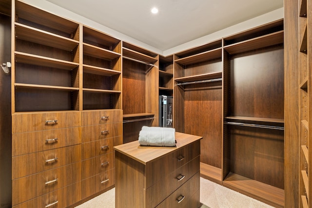 walk in closet featuring light carpet