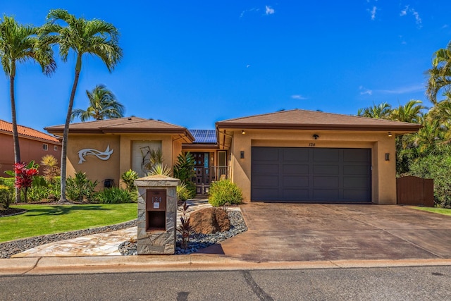 view of front of property with a front lawn and a garage