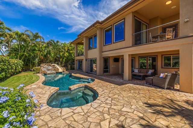 view of swimming pool featuring a patio, outdoor lounge area, and an in ground hot tub