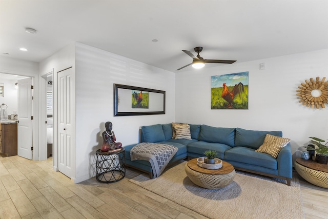 living room featuring recessed lighting, ceiling fan, light wood-style flooring, and baseboards