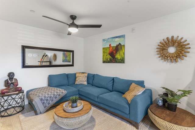 living area with a ceiling fan and wood finished floors