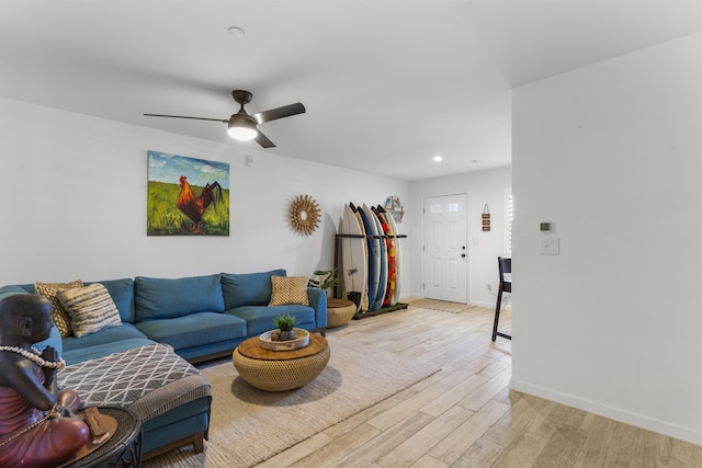 living area featuring baseboards, recessed lighting, and light wood-style floors