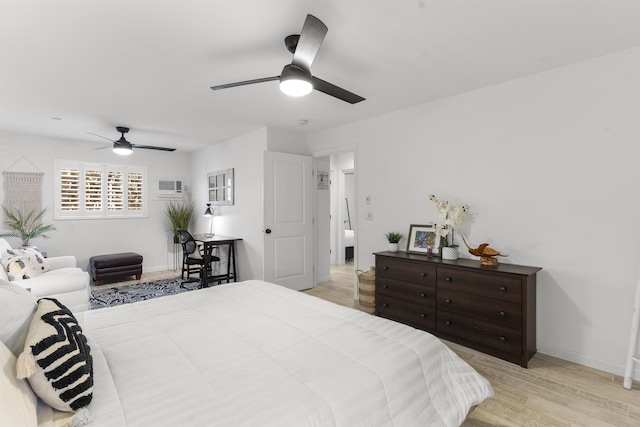 bedroom with light wood-style floors, ceiling fan, and baseboards