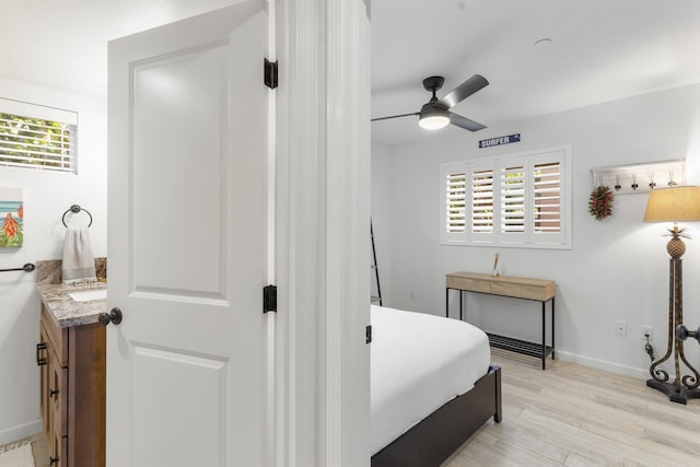 bedroom with a ceiling fan, light wood-style flooring, and baseboards