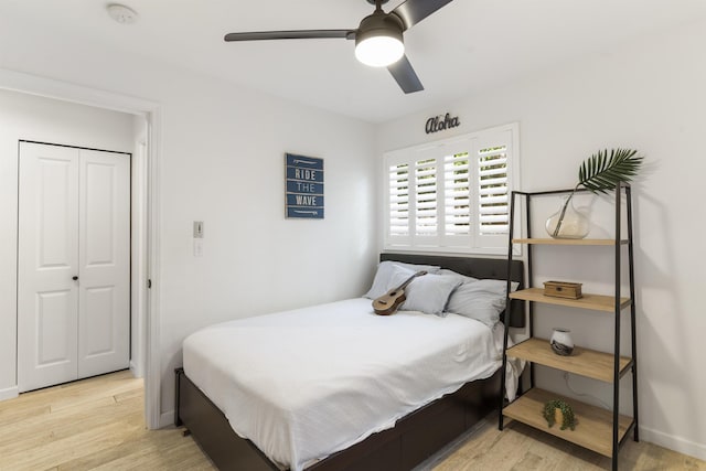 bedroom featuring a closet, wood finished floors, a ceiling fan, and baseboards