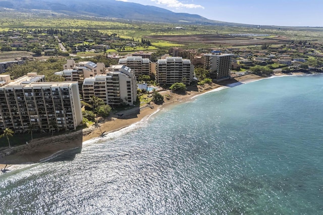 aerial view with a view of the beach, a city view, and a water and mountain view