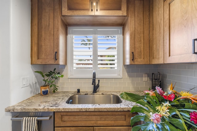 kitchen featuring brown cabinets and a sink