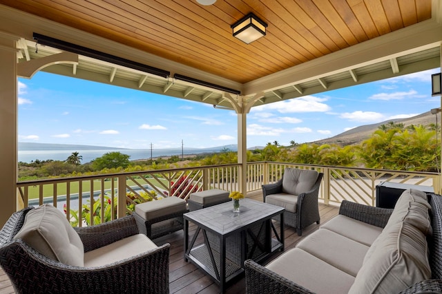 deck with an outdoor hangout area and a mountain view