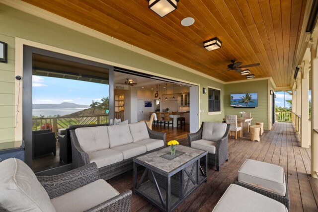 wooden terrace featuring an outdoor living space, a mountain view, and ceiling fan