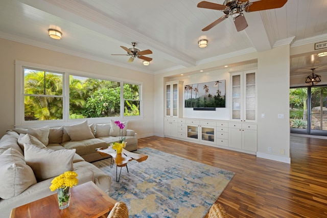 living room featuring ornamental molding, ceiling fan, wood finished floors, and baseboards