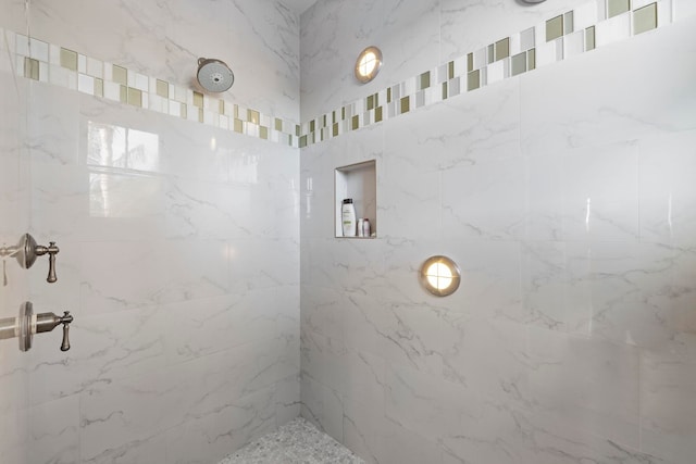 bathroom with tiled shower