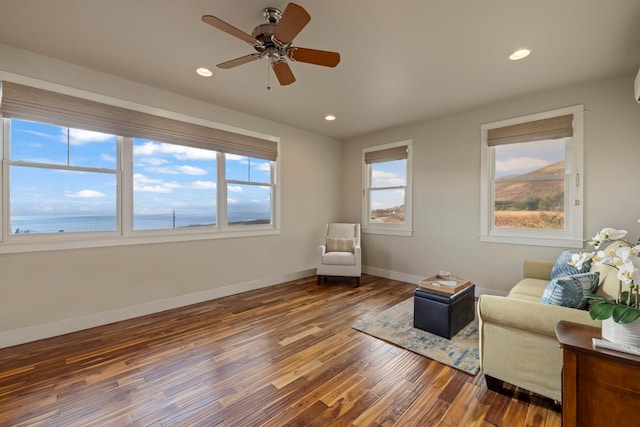 living area with wood finished floors, baseboards, a ceiling fan, and recessed lighting