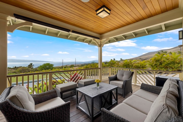 deck with a mountain view and an outdoor hangout area