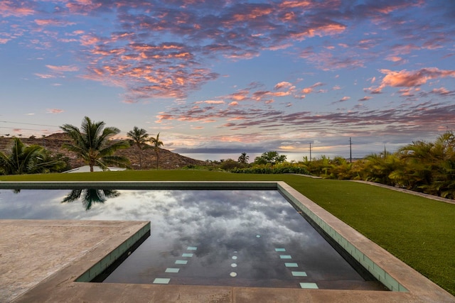 view of pool at dusk