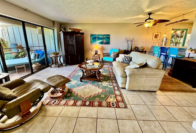 tiled living room with ceiling fan and a textured ceiling