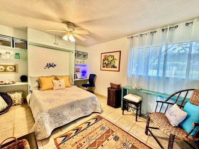 tiled bedroom with a textured ceiling and ceiling fan