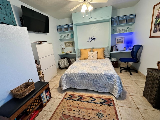 bedroom featuring light tile patterned flooring, a textured ceiling, and ceiling fan