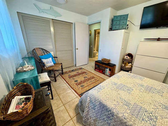 tiled bedroom featuring a closet