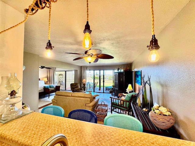 dining space with vaulted ceiling, ceiling fan, and a textured ceiling