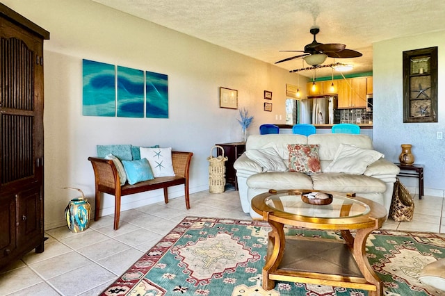 tiled living room with ceiling fan and a textured ceiling