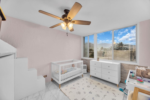 111 Kahului Beach Rd Unit D402, Kahului, HI 96732 - bedroom featuring a nursery area and a ceiling fan