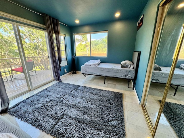 tiled bedroom featuring access to outside and multiple windows