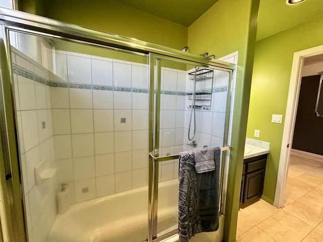 bathroom featuring bath / shower combo with glass door and vanity