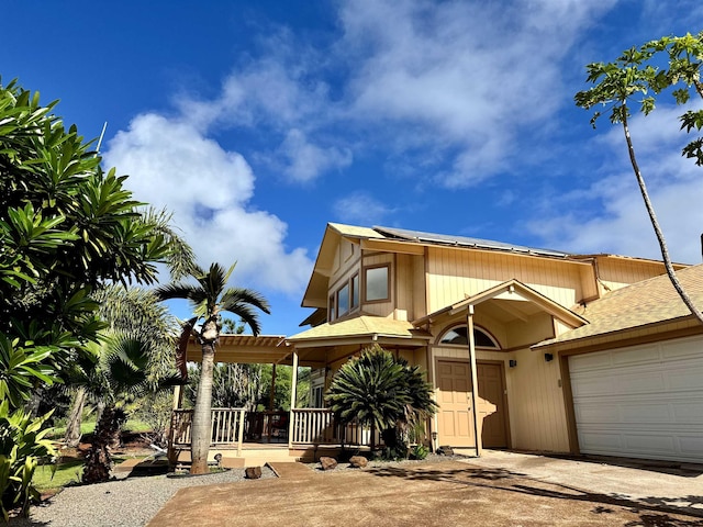 view of front of property featuring a garage and covered porch