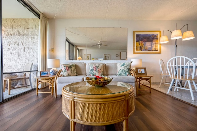 sitting room with ceiling fan, a textured ceiling, and dark hardwood / wood-style floors