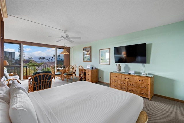 45 Kai Ala Dr Unit A409, Lahaina, HI 96761 - bedroom featuring carpet flooring, baseboards, access to exterior, ceiling fan, and a textured ceiling