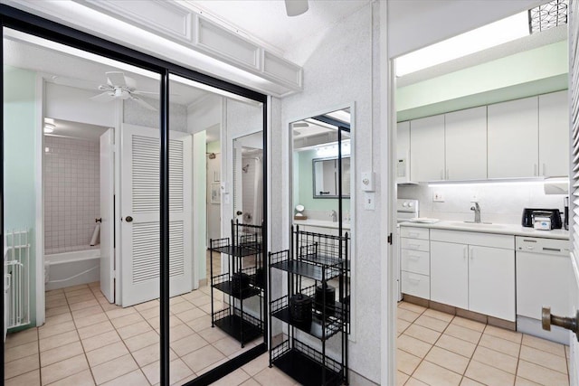 45 Kai Ala Dr Unit A409, Lahaina, HI 96761 - kitchen with light tile patterned floors, a ceiling fan, a sink, light countertops, and white dishwasher