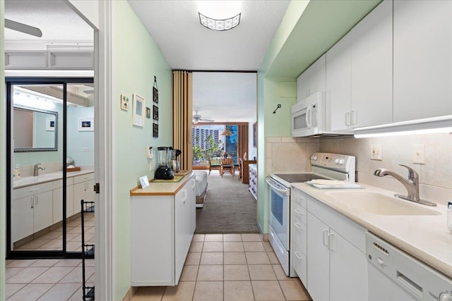 45 Kai Ala Dr Unit A409, Lahaina, HI 96761 - kitchen with white appliances, a sink, light countertops, and white cabinetry