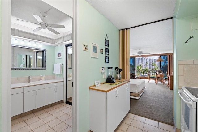 45 Kai Ala Dr Unit A409, Lahaina, HI 96761 - kitchen with a ceiling fan, white electric range oven, light tile patterned floors, and white cabinets
