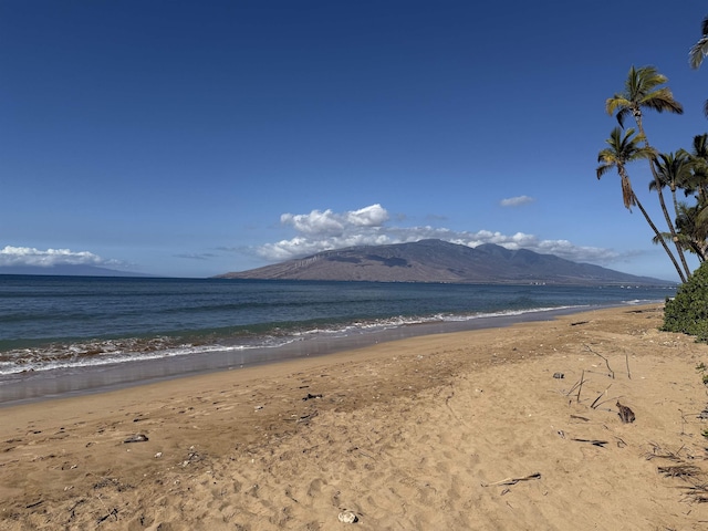 property view of mountains featuring a view of the beach and a water view