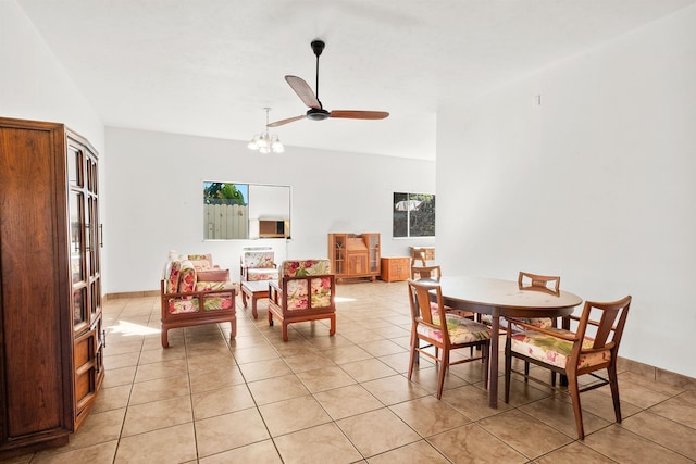 tiled dining room with ceiling fan with notable chandelier