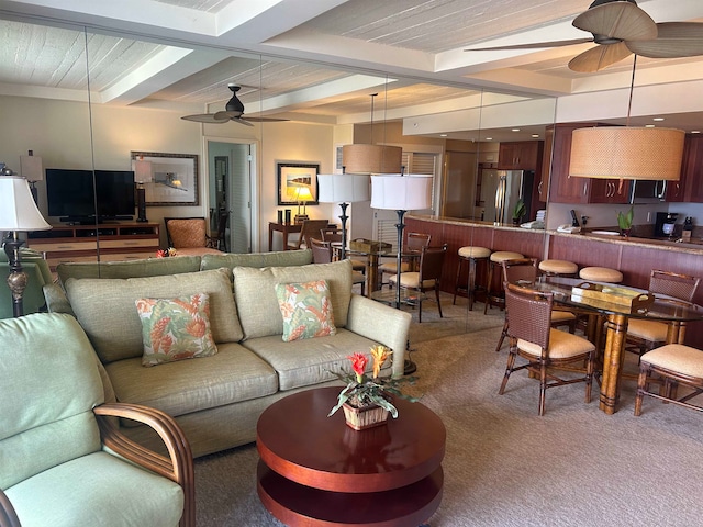 carpeted living room with beam ceiling and ceiling fan