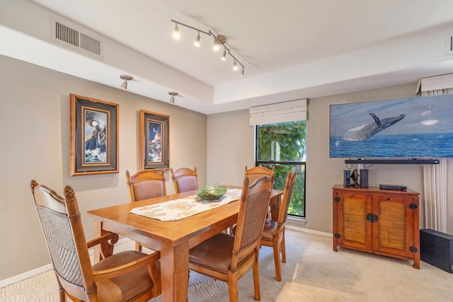 150 Puukolii Rd Unit 18, Lahaina, HI 96761 - dining room featuring light carpet, baseboards, and rail lighting