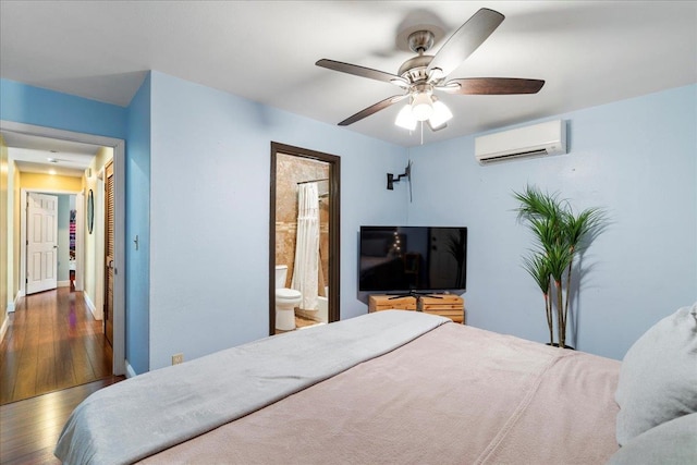 980 Kuhio Pl, Wailuku, HI 96793 - bedroom featuring a wall mounted air conditioner, wood finished floors, ensuite bathroom, and ceiling fan