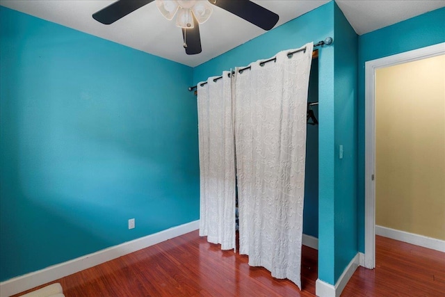 980 Kuhio Pl, Wailuku, HI 96793 - unfurnished bedroom featuring wood finished floors, baseboards, and a ceiling fan