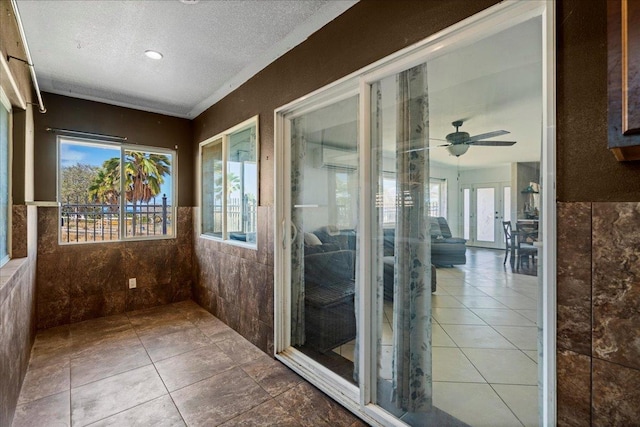 980 Kuhio Pl, Wailuku, HI 96793 - unfurnished sunroom with tile walls, plenty of natural light, a textured ceiling, tile patterned floors, and ceiling fan