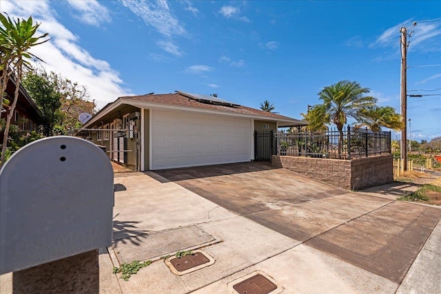 980 Kuhio Pl, Wailuku, HI 96793 - view of side of property featuring a gate, roof mounted solar panels, and a garage