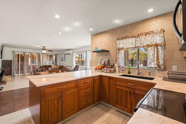 980 Kuhio Pl, Wailuku, HI 96793 - kitchen featuring a peninsula, a sink, open floor plan, recessed lighting, and brown cabinets